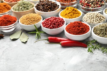Different aromatic spices on grey table, closeup. Space for text