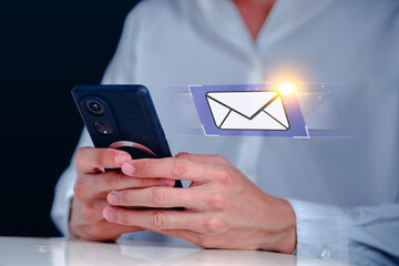 Hand Holding Smartphone with Email Icon in a Modern Digital Context