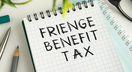 A spiral notebook with the word Fringe Benefit Tax written on it