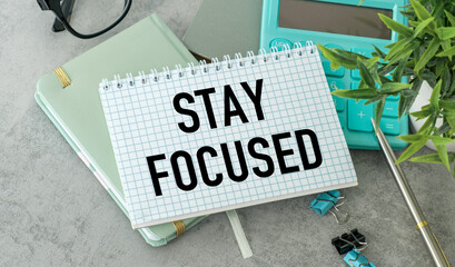 A notebook with the words Stay focused written on it