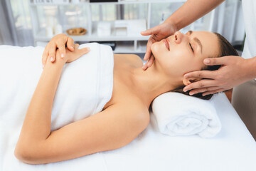 Caucasian woman enjoying relaxing anti-stress head massage and pampering facial beauty skin...