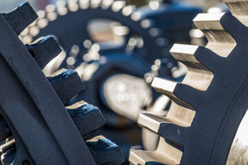 Detailed view of interlocking gears working together in a mechanical system during daylight