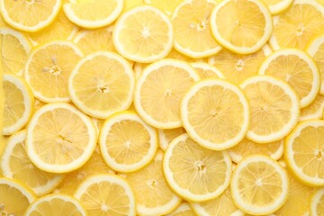 Slices of fresh lemons as background, top view
