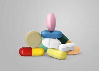 Many different antibiotic pills on grey background