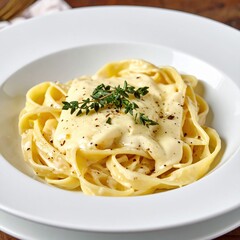 Creamy fettuccine alfredo with herbs in white bowl