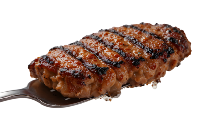 Grilled meat patty on spatula