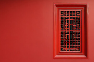 An intricate, geometric red lattice window adorns a vibrant red wall, creating a striking contrast and a sense of traditional design.