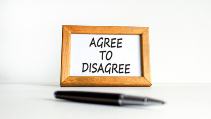 Agree to disagree symbol. Concept words Agree to disagree on beautiful wooden picture frame. Black...