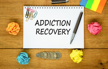 Addiction recovery symbol. Concept words Addiction recovery on beautiful white note. Beautiful wooden table wooden background. Black pen. Psychology addiction recovery concept. Copy space.