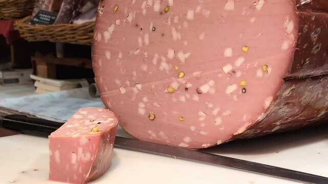 Gourmet mortadella preparation in a bustling market showcasing artisanal italian craftsmanship. Zoom in.