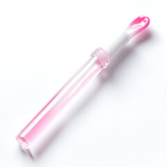 Eye serum applicator with transparent tube and pink serum on a white background in plain studio lighting