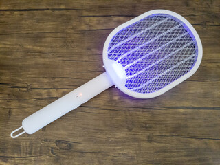 Multifunctional mosquito killer in the shape of a racket and with a lamp
