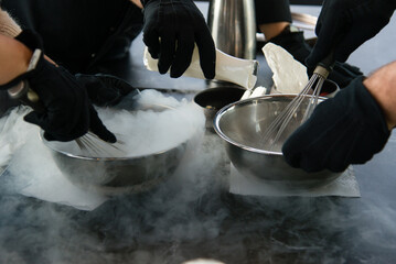 Cooking chef making ice cream added liquid nitrogen, process of making ice cream dessert