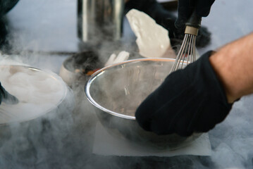 Cooking chef making ice cream added liquid nitrogen, process of making ice cream dessert