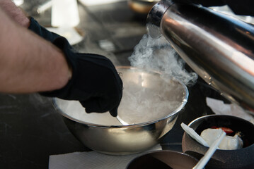 Cooking chef making ice cream added liquid nitrogen, process of making ice cream dessert