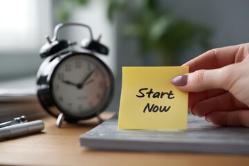 Motivational Sticky Note "Start Now" with Clock for Beating Procrastination Concept