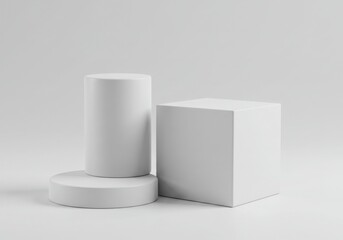 Geometric shapes arrangement including a cube and two cylinders isolated on gray background