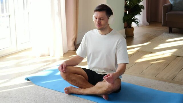 Practicing mindfulness and meditation at home in a sunlit living room during afternoon hours