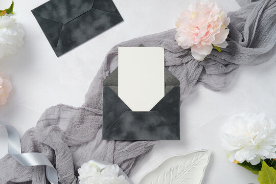 Elegant wedding stationery with floral and textile accents