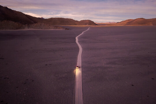 Solitary Vehicle on Remote Desert Road at Sunset in the argentine Puna