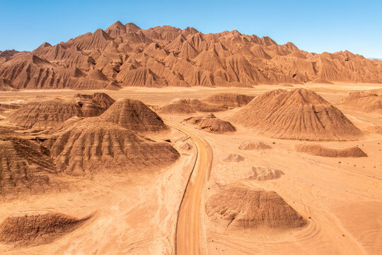 Rugged desert landscape with mountain range and dusty road in the Puna
