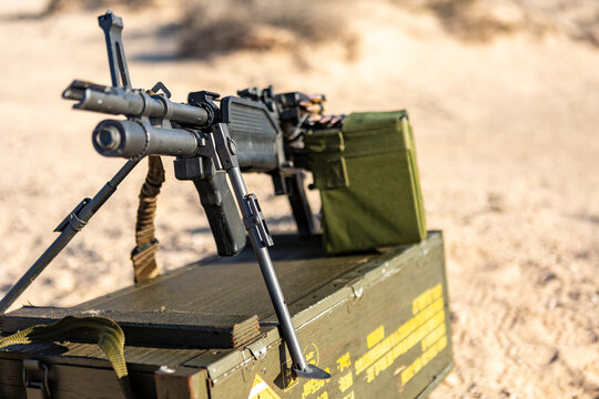 Military Machine Gun Displayed on Wooden Ammo Crate in Desert