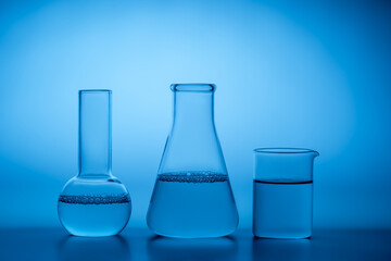 Glassware in laboratory with blue lighting and water