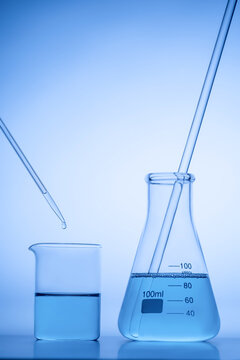 Laboratory Glassware with Blue Liquid and Pipette