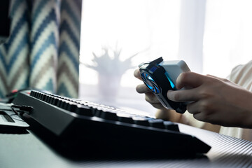 Teenage Gamer Immersed in Console and Keyboard Setup
