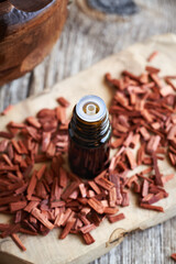 Red sandalwood essential oil in a glass bottle
