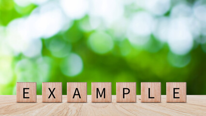 Example concept, Example word written on wooden block, example text on table, Business and example...