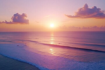 Fototapeta premium Surfers glide across vibrant waves at sunset in ocean paradise, Drone shot of surfers riding waves in ocean at beautiful sunrise in Bali