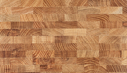 Oak wooden board texture as background, top view. Natural durable end grain hardwood cutting board.