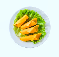 cheddar cheese rolls in a white plate isolated on a white background, top view.