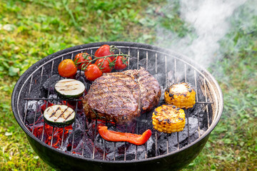 beef steak and vegetables on grill