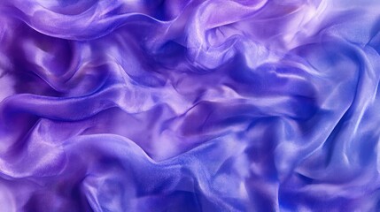 Fototapeta premium Draped sheer fabric in shades of purple and blue, exhibiting a flowing, wavy texture