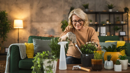 one woman florist take care grow cultivate plants at home