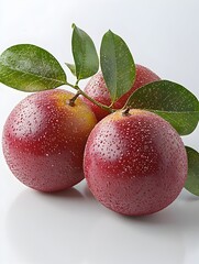 Three ripe red passion fruits with green leaves sit on a bright white background showcasing their juicy texture and vibrant color.