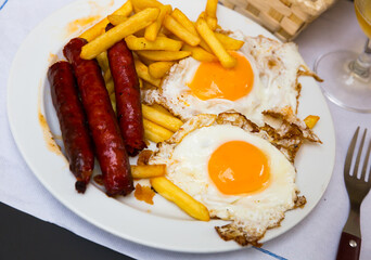 Huevos con chistorra. Scrambled eggs with sausage and potatoes. Spanish cuisine