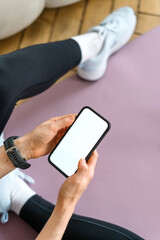 Fitness tracker app in use during home workout session by a young woman