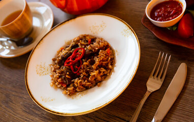Delicious fragrant pilau with lamb meat garnished with thin slices of red hot pepper. Typical oriental dish