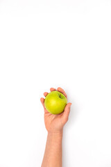 Caucasian female hand holding a green Granny Smith apple on white background with a space for text