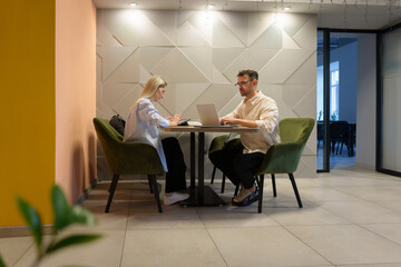 Collaborative business meeting at a contemporary workspace, emphasizing teamwork and productivity