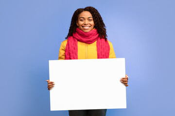 Happy Black Lady Holding Empty White Poster Board Advertising Winter Offer Standing On Purple...
