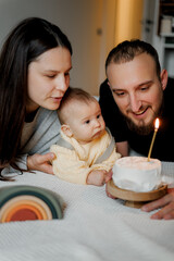 a candid photo of a young family and a long-awaited baby in their arms, selective focus, noise...