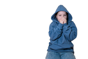 Young person in blue hoodie with a sad gaze, looking directly at camera with hands near face. Isolated on transparent background