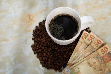 São Paulo, Brazil - April 30, 2025, Cup of coffee with coffee beans and Brazilian real notes