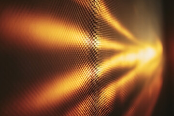 Abstract golden light reflections on a dark textured metallic surface.