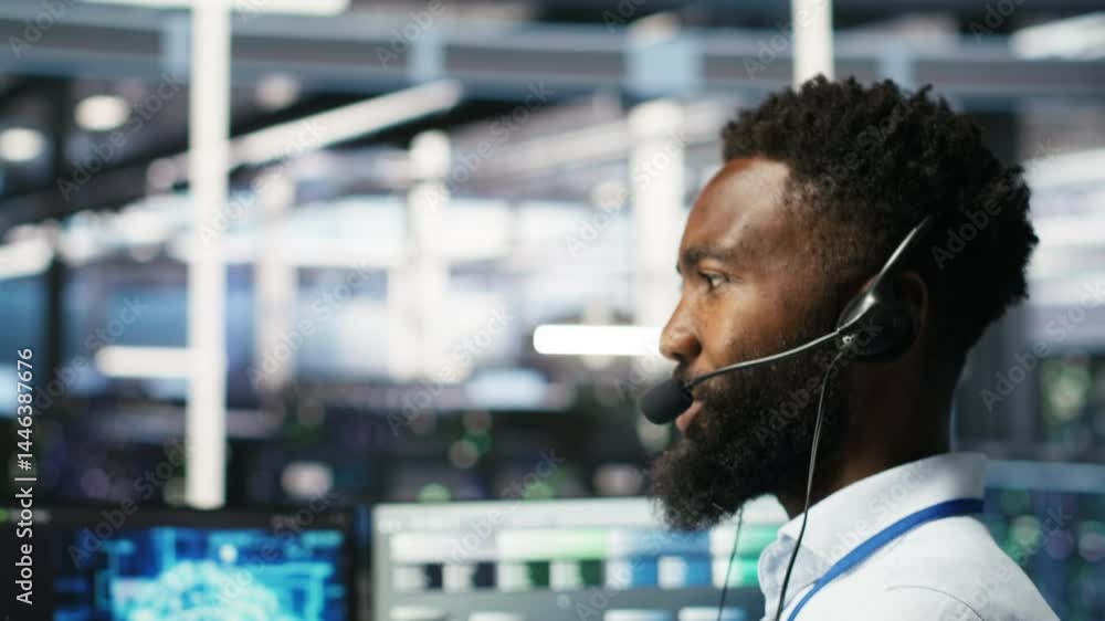 Poster data center employee talking in headset mic, coordinating technicians setting up hardware for artifi