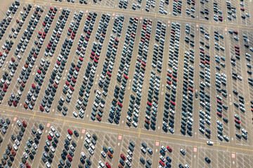 Obraz premium New cars parked for sale on automotive factory parking lot. Dealer vehicle inventory for import and export business commercial worldwide